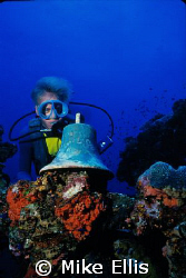 Capt. Kevin Davidson with the ships bell. Truk lagoon, Un... by Mike Ellis 